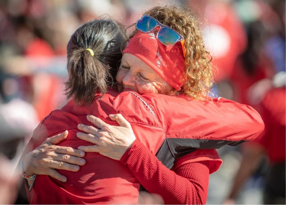 Two runners embrace at Boogie the Bridge